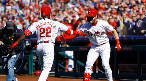 Phillies’ Andrew McCutchen and Bryce Harper celebrate after McCutchen’s home run on Opening Day (Matt Slocum)