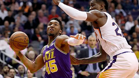 Utah Jazz guard Donovan Mitchell drives as Phoenix Suns center Deandre Ayton defends during a game on March 13, 2019, in Phoenix. (Matt York)