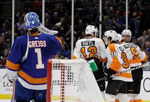 Islanders goaltender Thomas Greiss looks on  as Flyers’ Ryan Hartman (38) celebrates his goal with teammates  Saturday (Frank Franklin II)