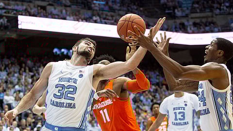 North Carolina’s Luke Maye (32) and Kenny Williams battle Syracuse’s Oshae Brissett  for a rebound Tuesday (Ben McKeown)