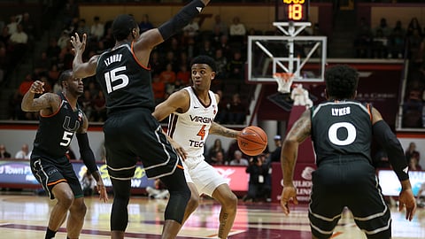 Virginia Tech’s Nickeil Alexander-Walker looks to pass the ball while guarded by Miami’s Zach Johnson, Ebuka Izundu and Chris Lykes during a game on March 8, 2019. (Matt Gentry/The Roanoke Times via AP)