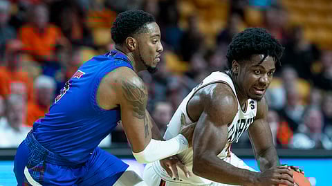 Campbell’s Chris Clemons drives past Presbyterian’s Davon Bell in a January game (Jason E. Miczek)