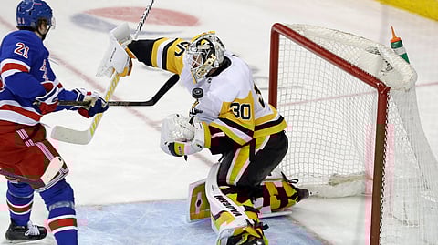 Penguins goalie Matt Murray makes an awkward save against the Rangers’ Brett Howden March 25 (Kathy Willens)