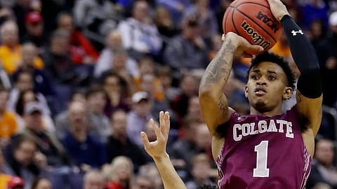Colgate’s Jordan Burns, right, shoots during the NCAA men’s college basketball tournament, Friday, March 22, 2019. (AP Photo/Tony Dejak)