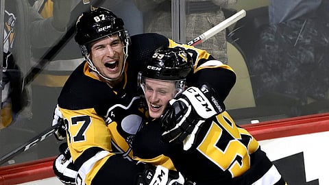 Sidney Crosby (left) celebrates Jake Guentzel’s game-winning goal for the Penguins Tuesday (Gene J. Puskar)
