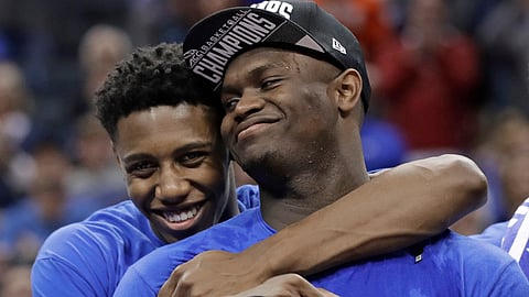 Duke’s RJ Barrett, left, hugs Zion Williamson after Duke defeated Florida State in the NCAA championship game of the ACC tournament on March 16, 2019.