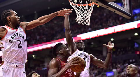 Rockets’ Clint Capela looks to score against Toronto’s Kawhi Leonard (2) and Pascal Siakem Tuesday (Frank Gunn/Canadian Press)