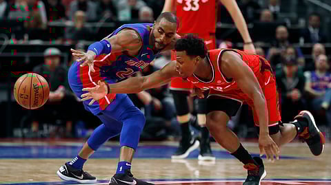 Detroit Pistons guard Wayne Ellington, left, and Toronto Raptors guard Kyle Lowry (7) reach for loose ball Sunday, March 3, 2019, in Detroit. (AP Photo/Carlos Osorio)