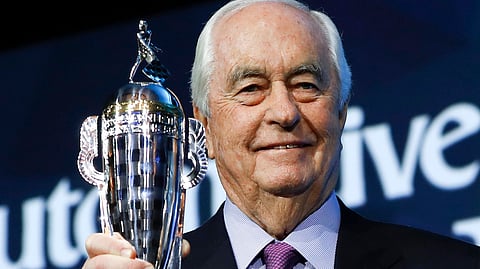 FILE - In this Jan. 16, 2019, file photo, Roger Penske holds his “Baby Borg” trophy in Detroit. Joey Logano’s win in Las Vegas was the fourth victory for one of Roger Penske’s cars in seven days. It’s quite the start to the year for Penske, who last month was inducted into NASCAR’s Hall of Fame, feted at the Royal Automobile Club in Pall Mall, London and celebrated his 82nd birthday. (AP Photo/Paul Sancya, File)