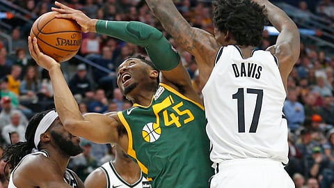 Utah Jazz guard Donovan Mitchell goes to the basket as Brooklyn Nets forward Ed Davis defends during a game on March 16, 2019.