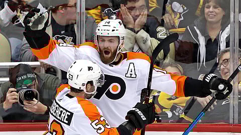 Philadelphia Flyers’ Sean Couturier celebrates with Shayne Gostisbehere after getting the game-winning goal past Pittsburgh Penguins goaltender Matt Murray in overtime of a game on March 17, 2019.