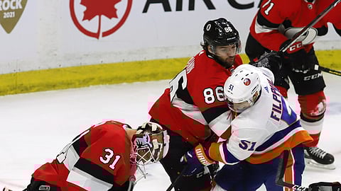 Senators goalie Anders Nilsson (31), Christian Wolanin (86) and Islander Valtteri Filppula (51) vie for the puck, Thursday, March 7, 2019. (Fred Chartrand/The Canadian Press via AP)