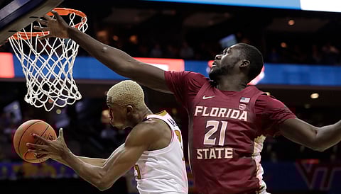 Virginia’s Mamadi Diakite drives past Florida State’s ChristKoumadje Friday (Chuck Burton)