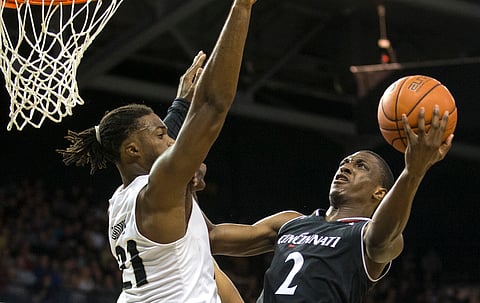 Cincinnati guard Keith Williams tries to shoot over Central Florida forward Chad Brown on March 7 (Willie J. Allen Jr.)