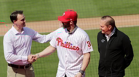 New Phillie Bryce Harper shakes hands with General Manager Matt Klentak as agent Scott Boras looks on Saturday (Lynne Sladky)