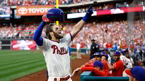 Philadelphia Phillies’ Bryce Harper celebrates after hitting a home run off Atlanta Braves relief pitcher Jesse Biddle during the seventh inning of the game on March 30, 2019.