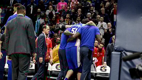 Sixers center Boban Marjanovic is helped off the court after being injured in New Orleans on Monday (Scott Threlkeld)