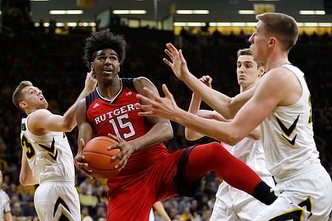Rutgers’ Myles Johnson battles three Iowa players for a rebound on March 2 (Charlie Neibergall)