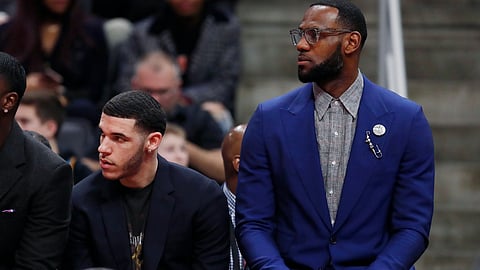 From left, Lakers’ Lance Stephenson, Lonzo Ball and LeBron James watch Lakers’ loss to Pistons Friday (Carlos Osorio)