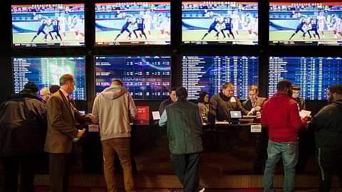 In this Thursday, Dec. 13, 2018, file photo, gamblers place bets in the temporary sports betting area at the SugarHouse Casino in Philadelphia. 