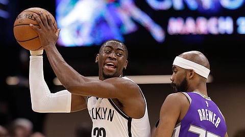 Brooklyn Nets guard Caris LeVert protects the ball from Sacramento Kings guard Corey Brewer during the game on March 19, 2019.
