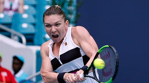 Simona Halep, of Romania, returns a volley to Wang Qiang, of China, during the Miami Open tennis tournament on March 27, 2019.