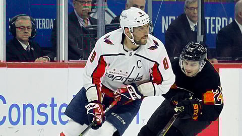 Washington Capitals’ Alex Ovechkin controls the puck while followed by Philadelphia Flyers’ Scott Laughton during an NHL hockey game on March 6, 2019. (Tom Mihalek)