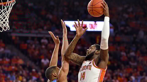 Clemson’s Elijah Thomas shoots over North Carolina’s Garrison Brooks on March 2 (Richard Shiro)