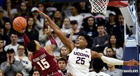 Temple’s Nate Pierre-Louis drives on Connecticut’s Josh Carlton in their game on March 7 (Stephen Dunn)
