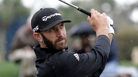 Dustin Johnson plays his shot from the third tee during the final round of The Players Championship golf tournament on March 17, 2019.