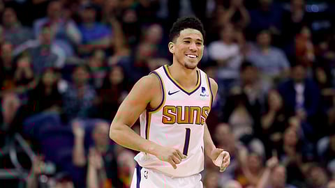 Phoenix Suns guard Devin Booker smiles after making a 3-pointer against the New York Knicks on March 6, 2019. (Matt York)