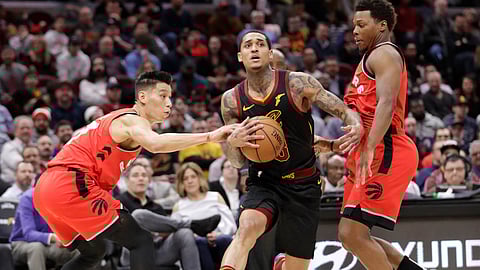 Cleveland’s Jordan Clarkson drives between Toronto’s Jeremy Lin (left) and Kyle Lowry Monday (Tony Dejak)
