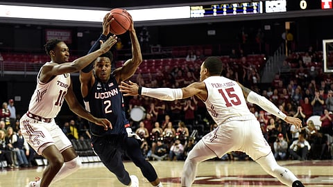Temple’s Shizz Alston Jr. and Nate Pierre-Louis defend against Connecticut’s Tarin Smith in the teams’ first meeting on Feb. 6 (Michael Perez)