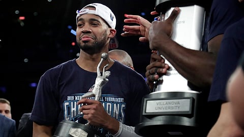 Villanova guard Phil Booth holds the Big East Tournament MVP trophy (Julio Cortez)