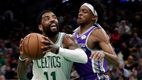 Boston’s Kyrie Irving drives against Sacramento’s De’Aaron Fox Thursday (Elise Amendola)