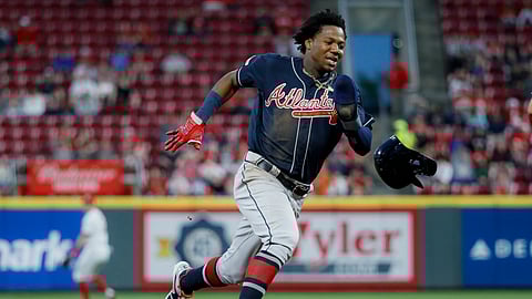 Atlanta Braves’ Ronald Acuna Jr. runs home to score on an error by Cincinnati Reds right fielder Yasiel Puig in the baseball game on April 24, 2019.