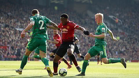 Watford’s Daryl Janmaat, left, and teammate Will Hughes, right, battle for the ball with Manchester United’s Anthony Martial, during the English Premier League soccer match between Manchester United and Watford on March 30, 2019. 