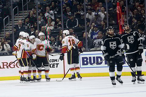 Flames players celebrate one of their seven goals against the Kings Monday (Ringo H.W. Chiu)