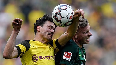 Saturday, Dortmund’s Thomas Delaney, left, with Wolfsburg’s Wout Weghorst, will have to use his head against favored Bayern Munich. (AP Photo/Martin Meissner)