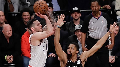 Sixers’ 76ers’ JJ Redick shoots over Brooklyn’s Spencer Dinwiddie on April 18 (Frank Franklin II)