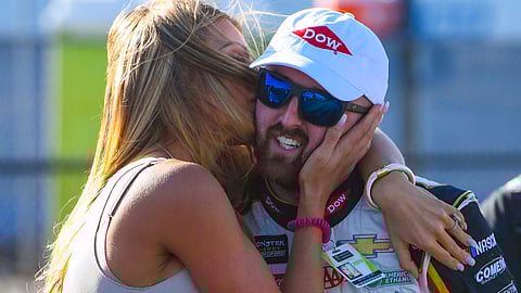 Whitney Dillon, left, kisses her husband, NASCAR Cup Series driver Austin Dillon after he captured the pole in qualifying for a NASCAR Cup Series auto race at Talladega Superspeedway on April 27, 2019.
