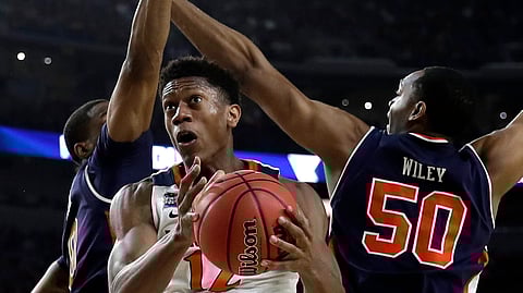 Virginia guard De’Andre Hunter drives to the basket past two Auburn players Saturday (David J. Phillip)