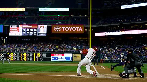Phillies’ Rhys Hoskins follows through on an RBI single off Twins pitcher Jake Odorizzi, Friday, April 5, 2019, in Philadelphia. (AP Photo/Matt Slocum)
