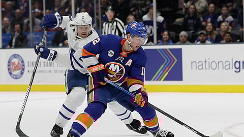 New York Islanders’ Josh Bailey drives past Toronto Maple Leafs’ Ron Hainsey during the game on April 1, 2019.