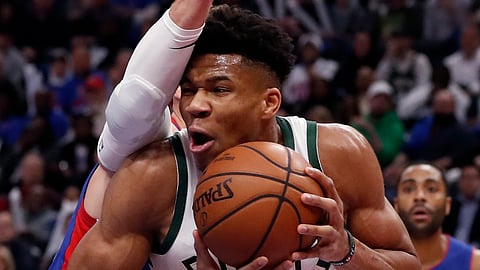 Milwaukee Bucks forward Giannis Antetokounmpo is defended by Detroit Pistons forward Blake Griffin during the first half of Game 3 of a first-round NBA basketball playoff series on April 20, 2019.