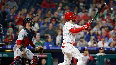 Philadelphia Phillies’ Bryce Harper, right, and Washington Nationals catcher Yan Gomes watch his three-run home run during the baseball game on April 9, 2019.