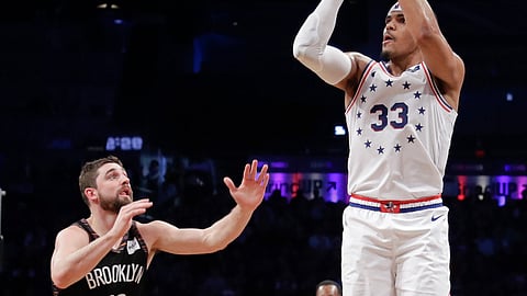 Brooklyn’s Joe Harris watches Sixers’ Tobias Harris make a three-pointer in Game 3 on April 18 (Frank Franklin III)