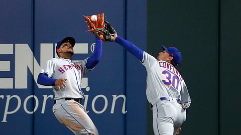 New York Mets center fielder Juan Lagares, left, nearly collides with right fielder Michael Conforto while catching a fly ball by St. Louis Cardinals’ Marcell Ozuna to end the third inning of a baseball game Friday, April 19, 2019, in St. Louis.
