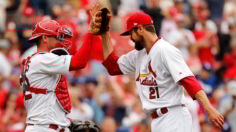 St. Louis Cardinals relief pitcher Andrew Miller, right, and catcher Matt Wieters celebrate an 11-7 victory over the Los Angeles Dodgers. (AP Photo/Jeff Roberson)