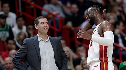 Celtics coach Brad Stevens chats with Miami guard Dwyane Wade during the second half Wednesday (Lynne Sladky)